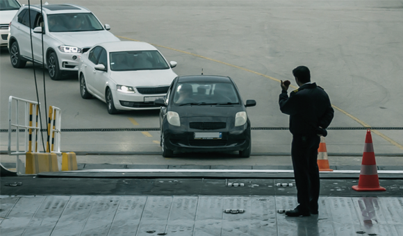 Person filming cars driving in a line