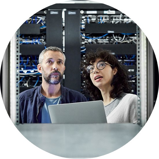 two workers looking at laptop