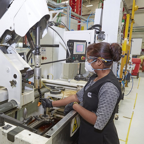 Cummins India employee working with parts