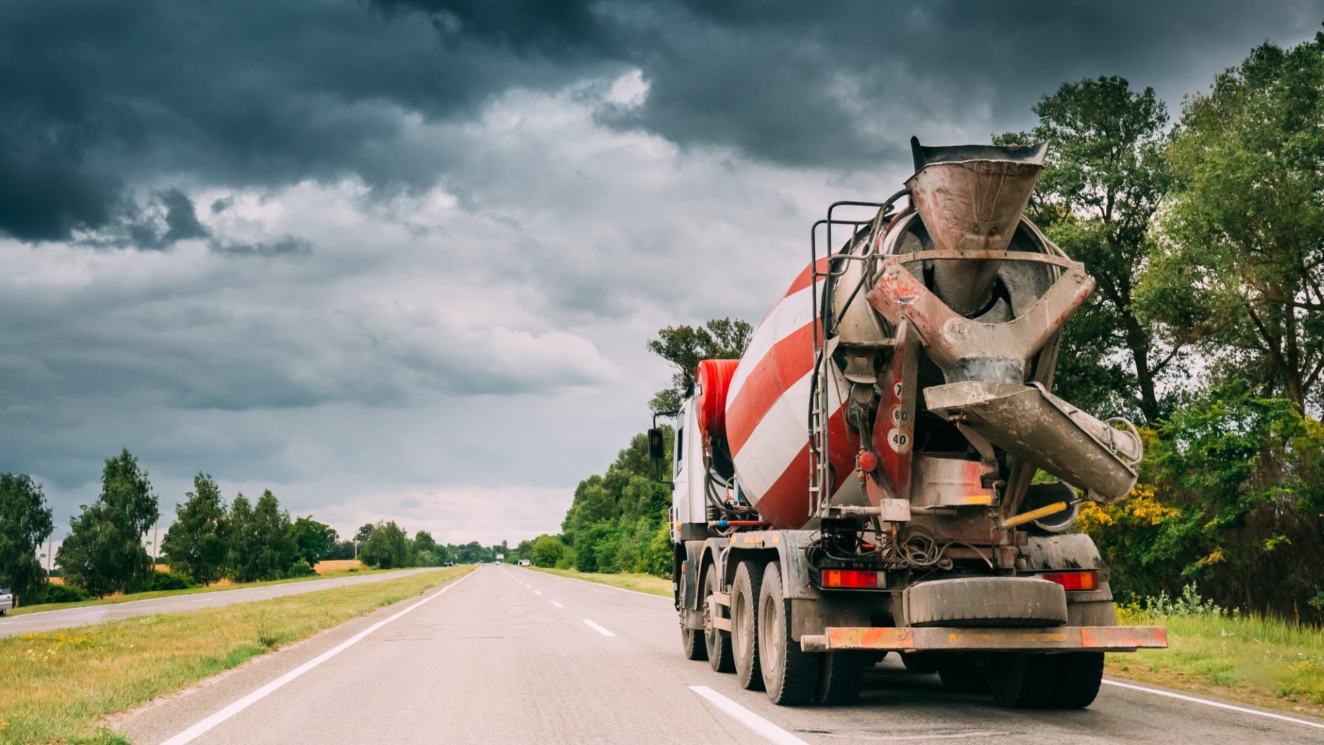 concrete mixer truck driving down road
