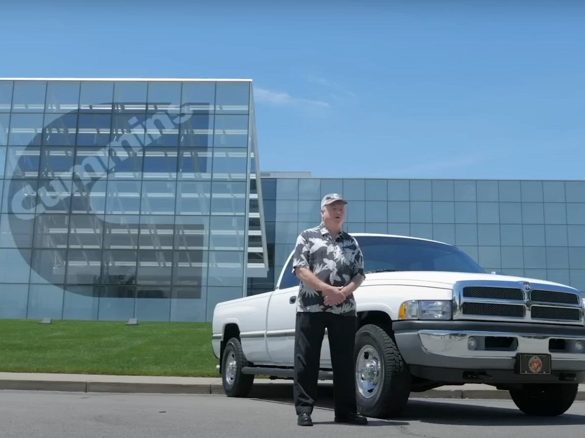 man standing next to pickup truck