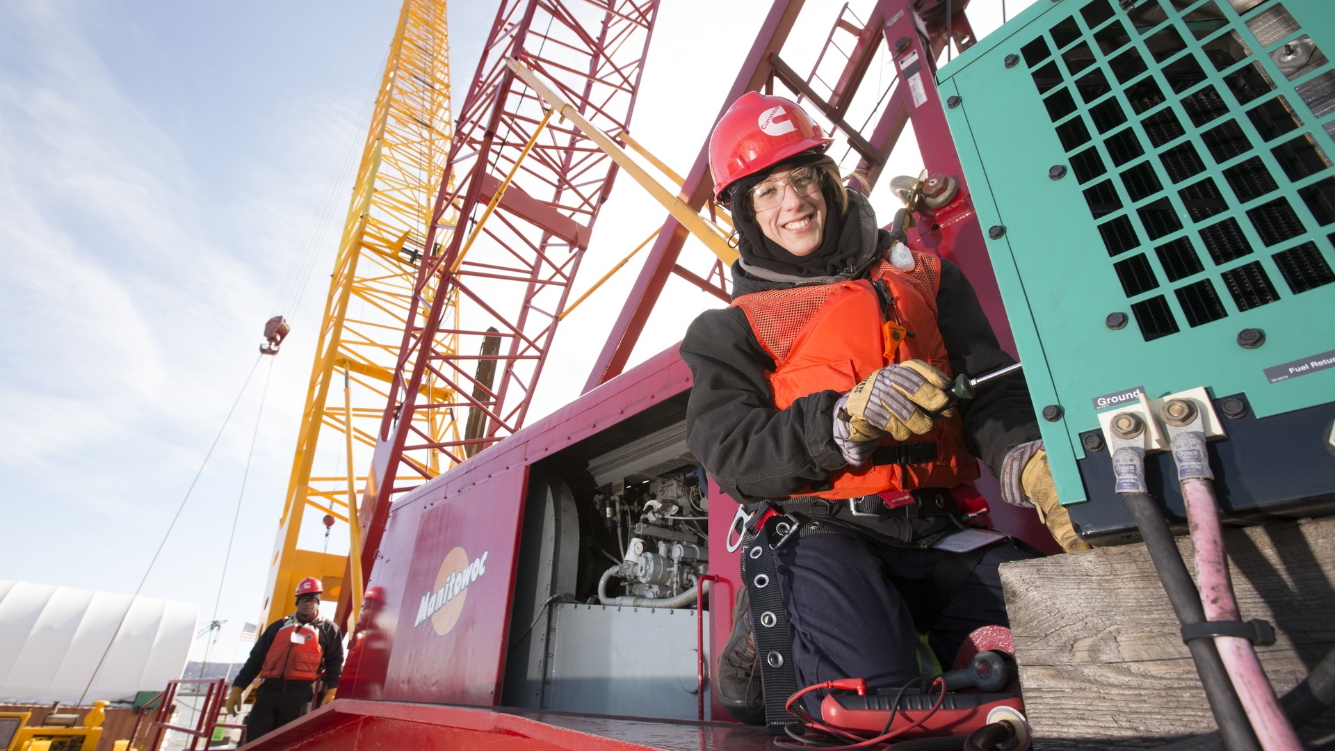 Cummins technician fixing a generator outside on a job site