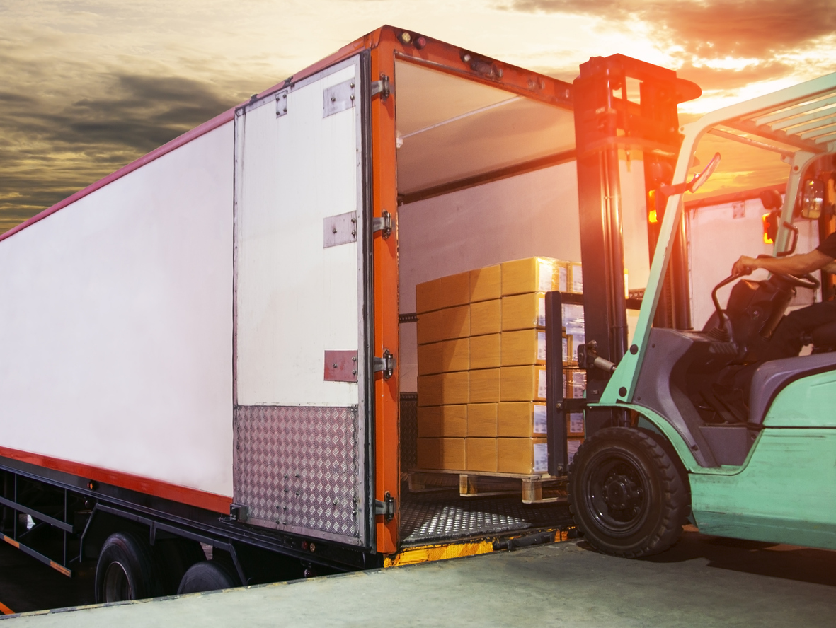 fork lift loading supplies into truck container