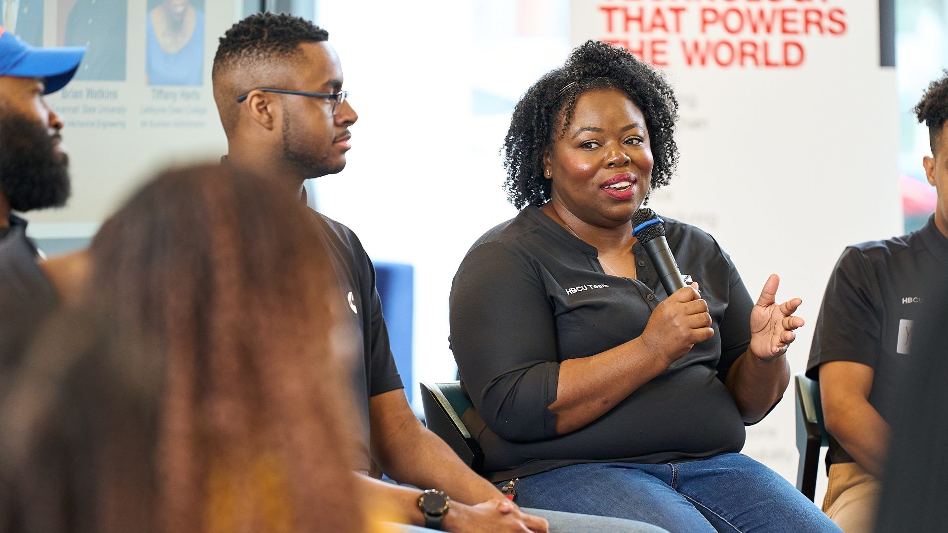 person speaking on stage for panel talk