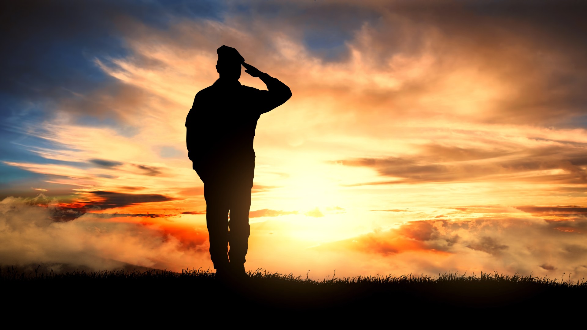 soldier saluting towards sunrise