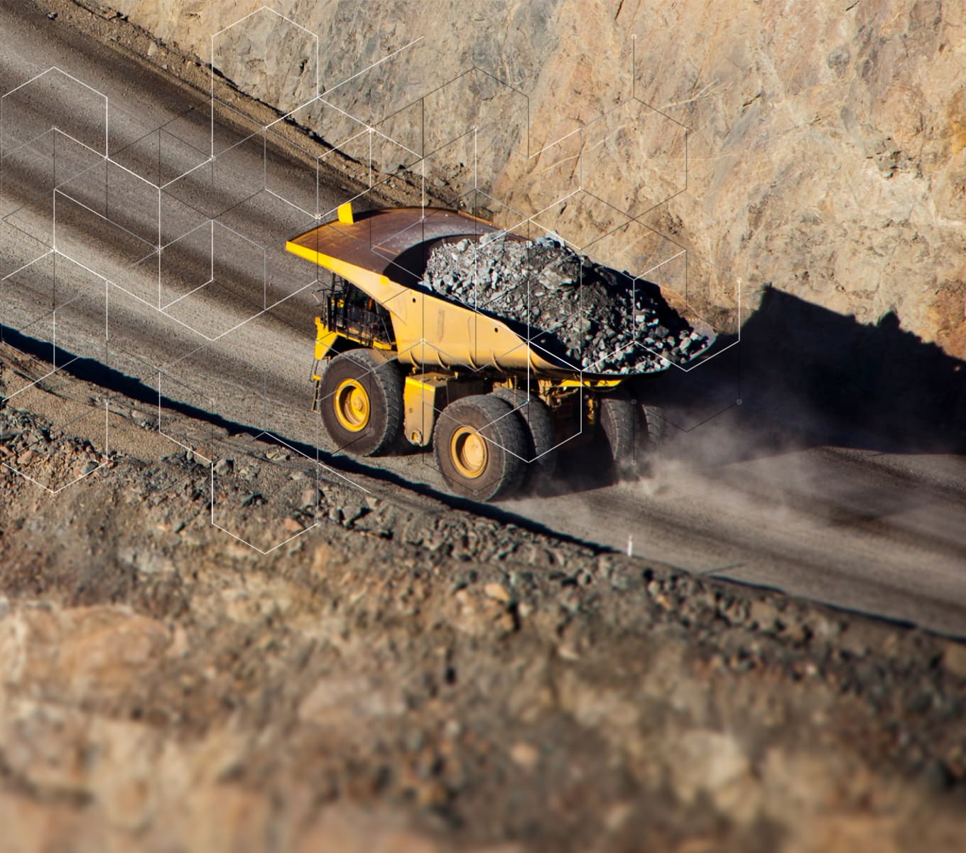 dump truck driving with rock on mine road