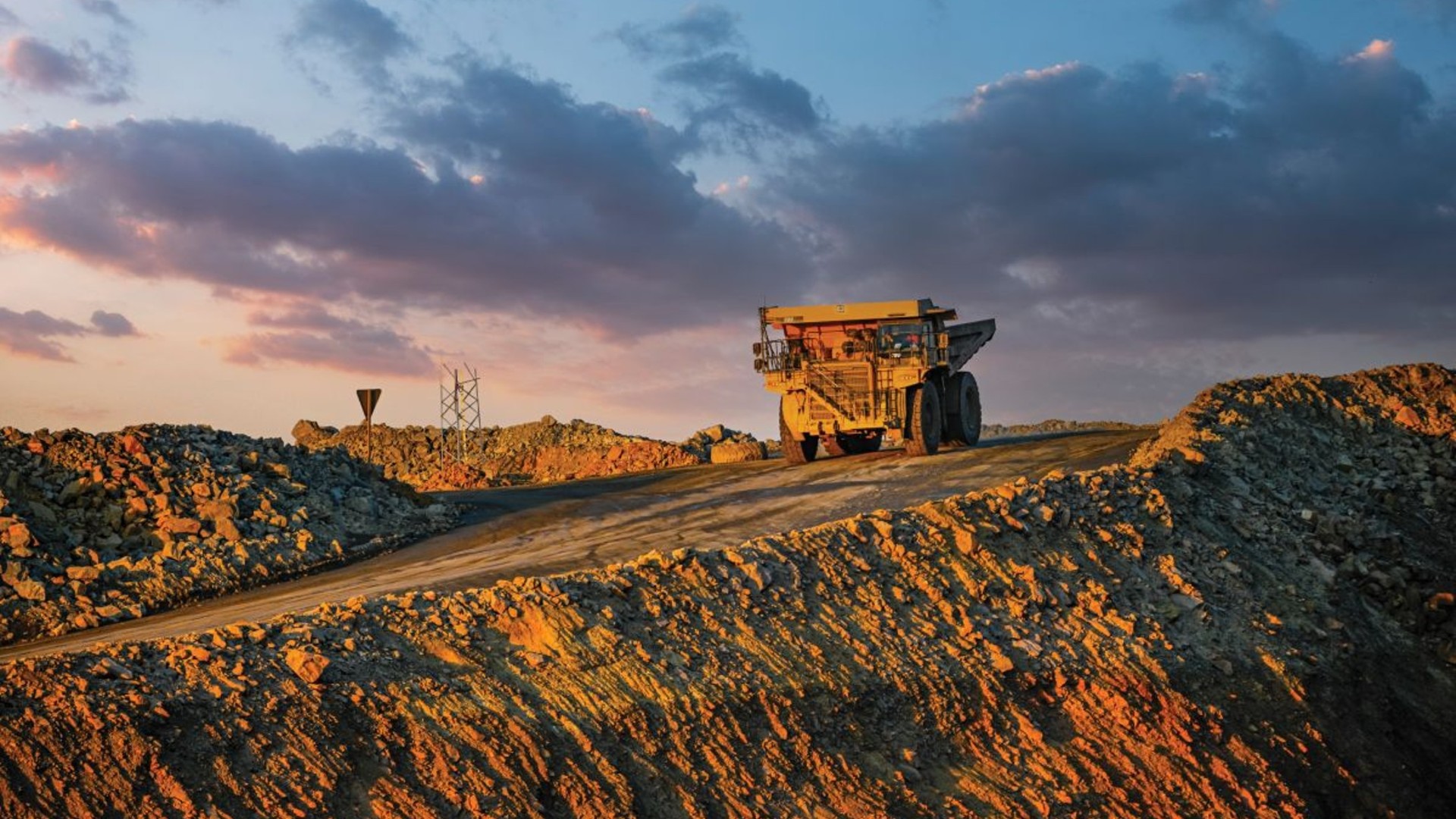 large mining tractor driving on dirt road