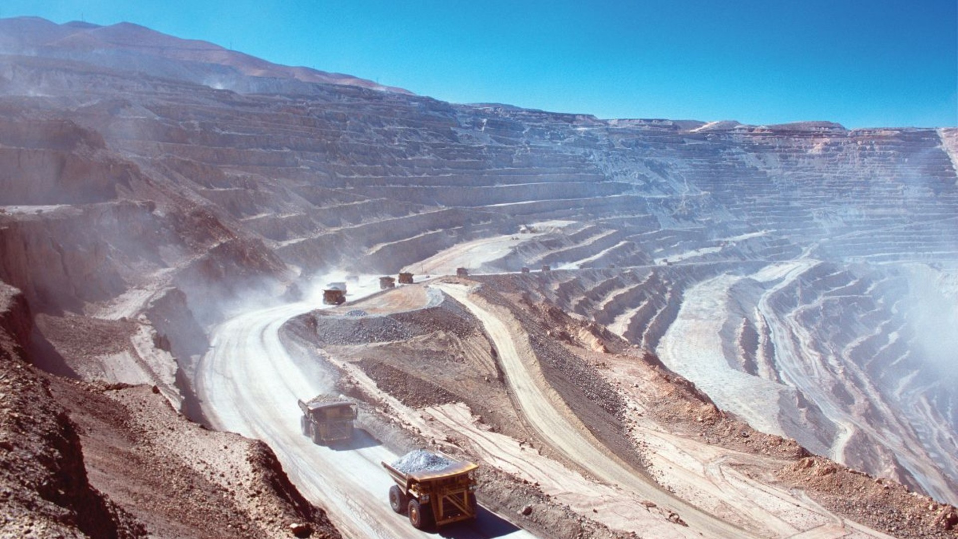 mining trucks driving in large mining site