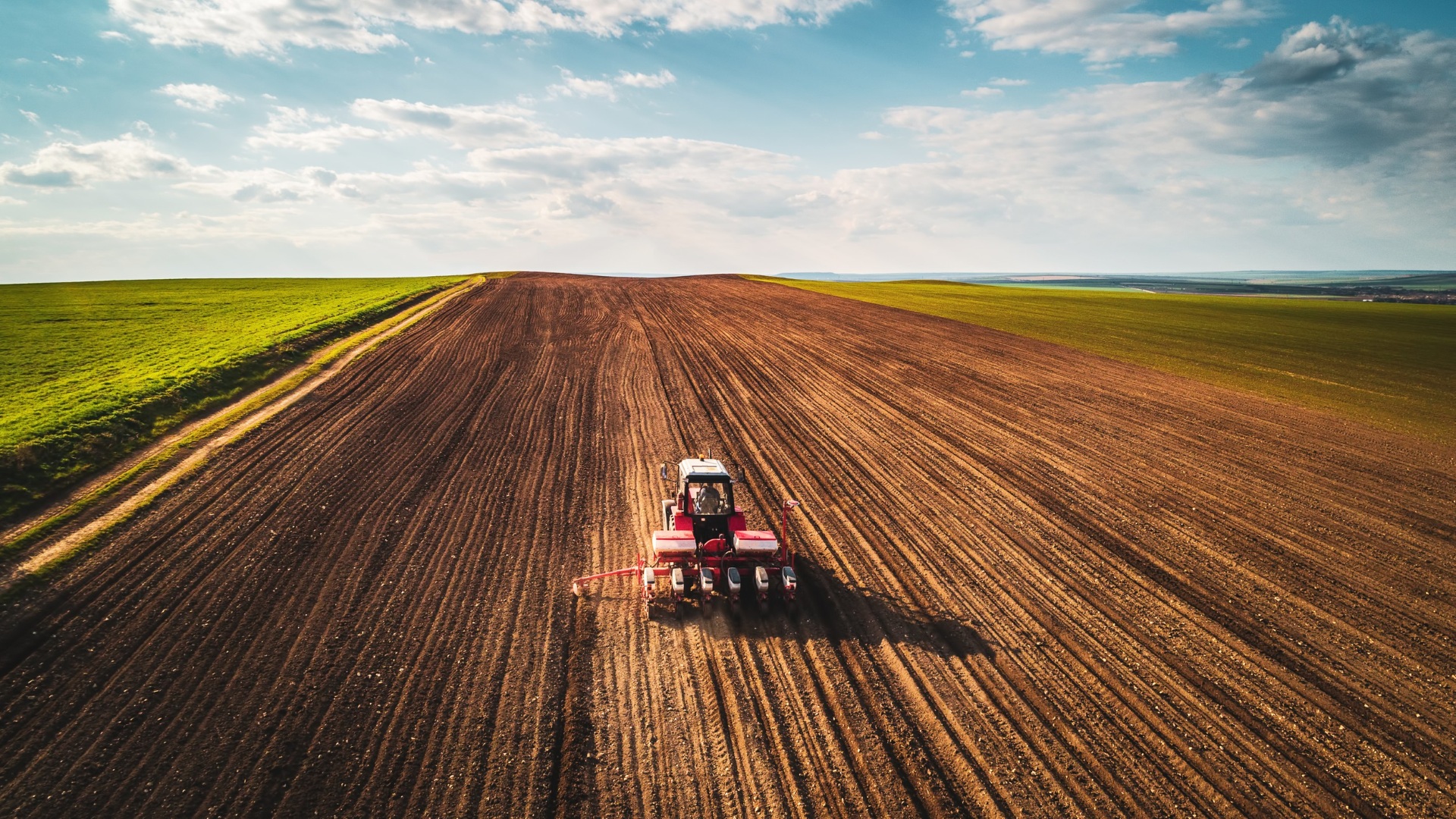 tractor driving in crop field