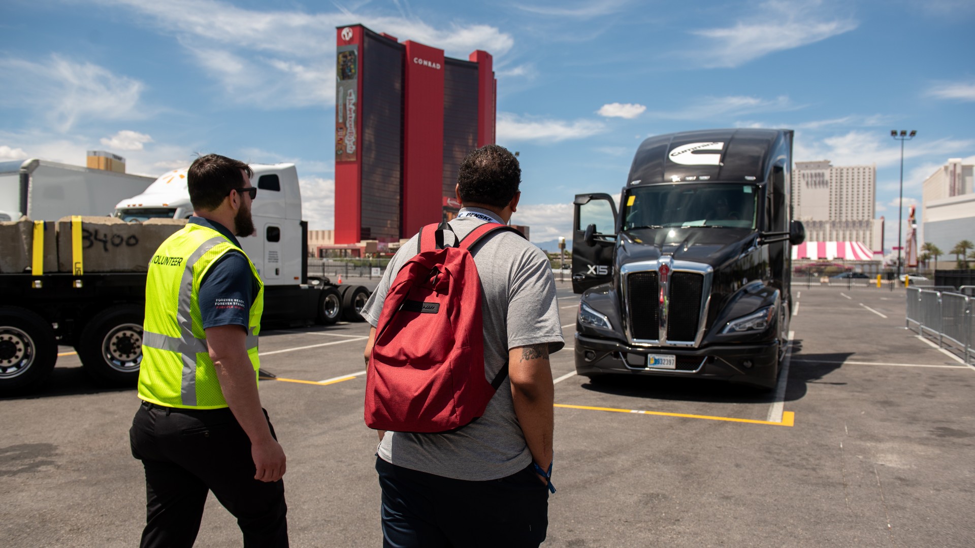 Customer looking at truck with Cummins X15 at a Forever Rising Tour spot