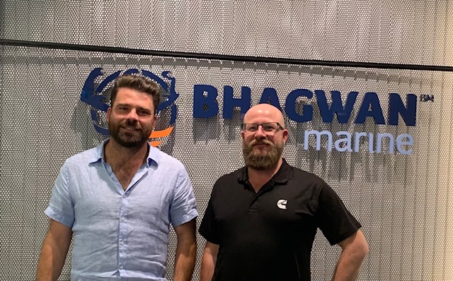 posing in front of Bhagwan sign