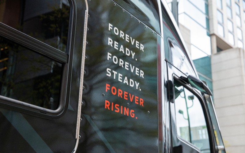 Truck with branding from the Forever Rising Tour on the door.