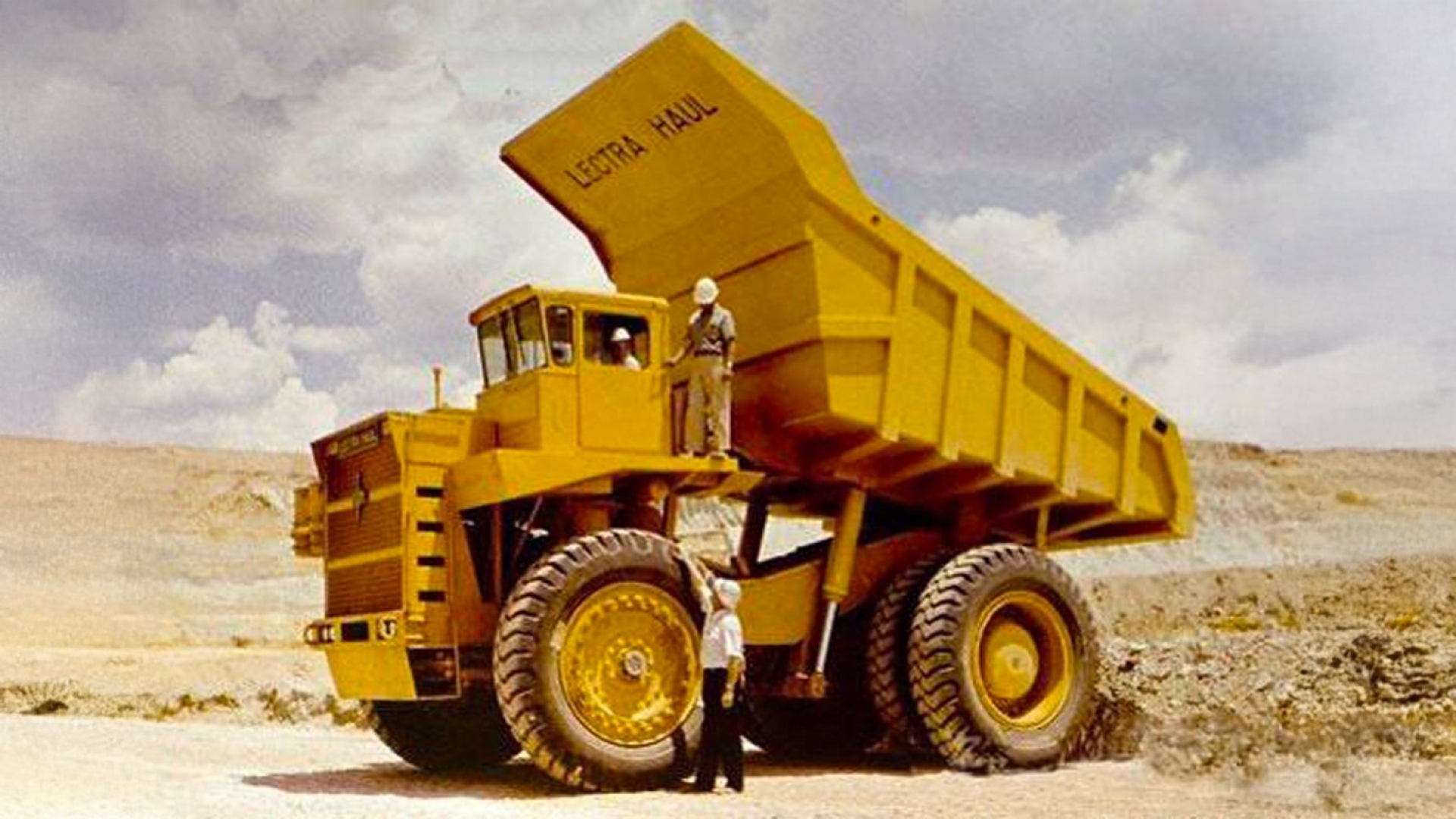 Man posing with Lectra Haul M-85 in desert