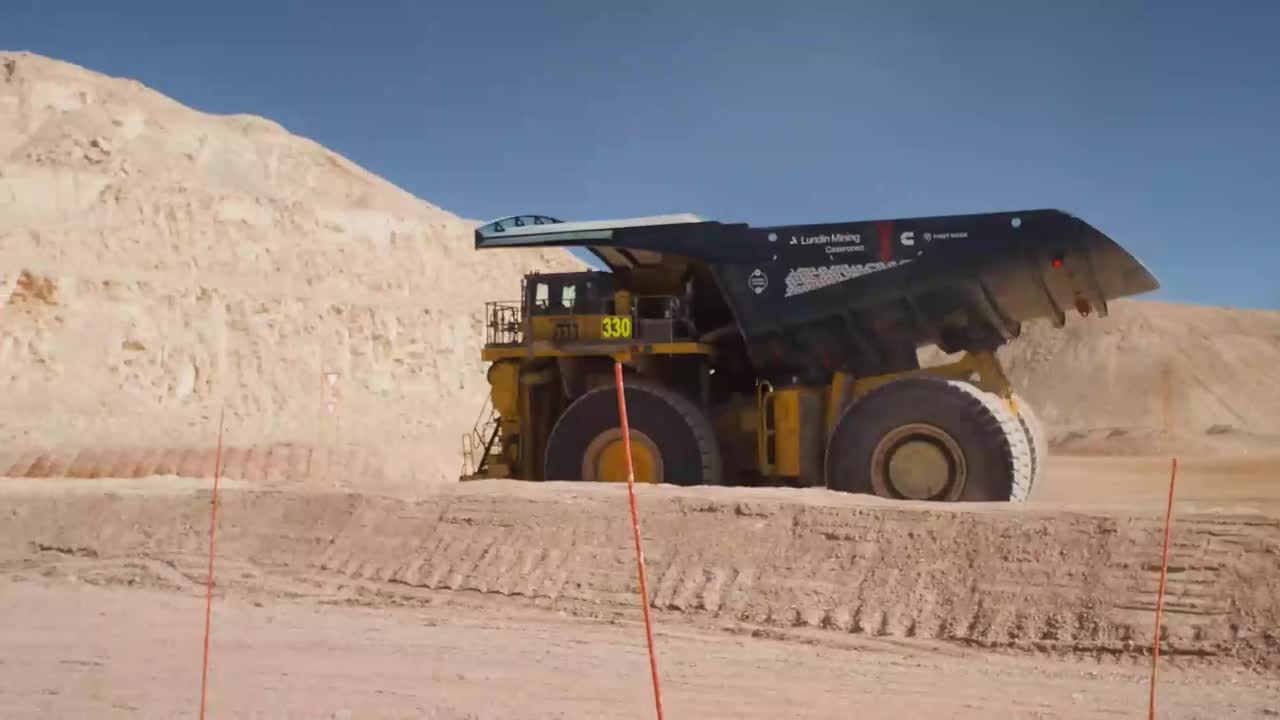 Mining haul truck driving through an open-pit mining site
