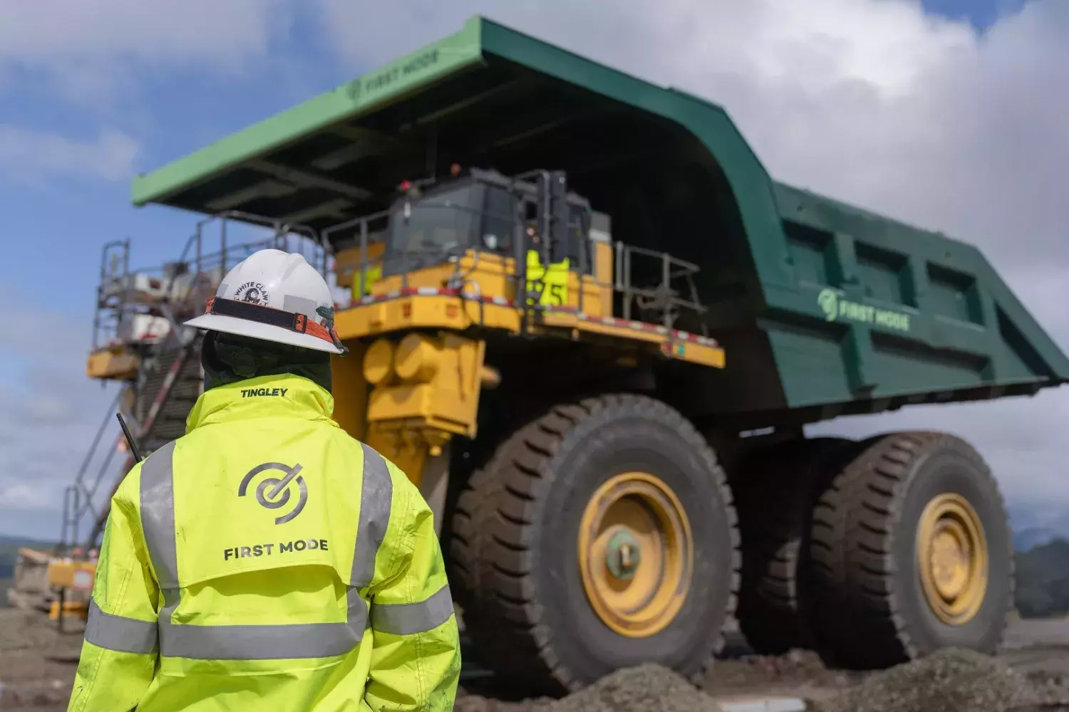 First Mode worker looking at their dump truck