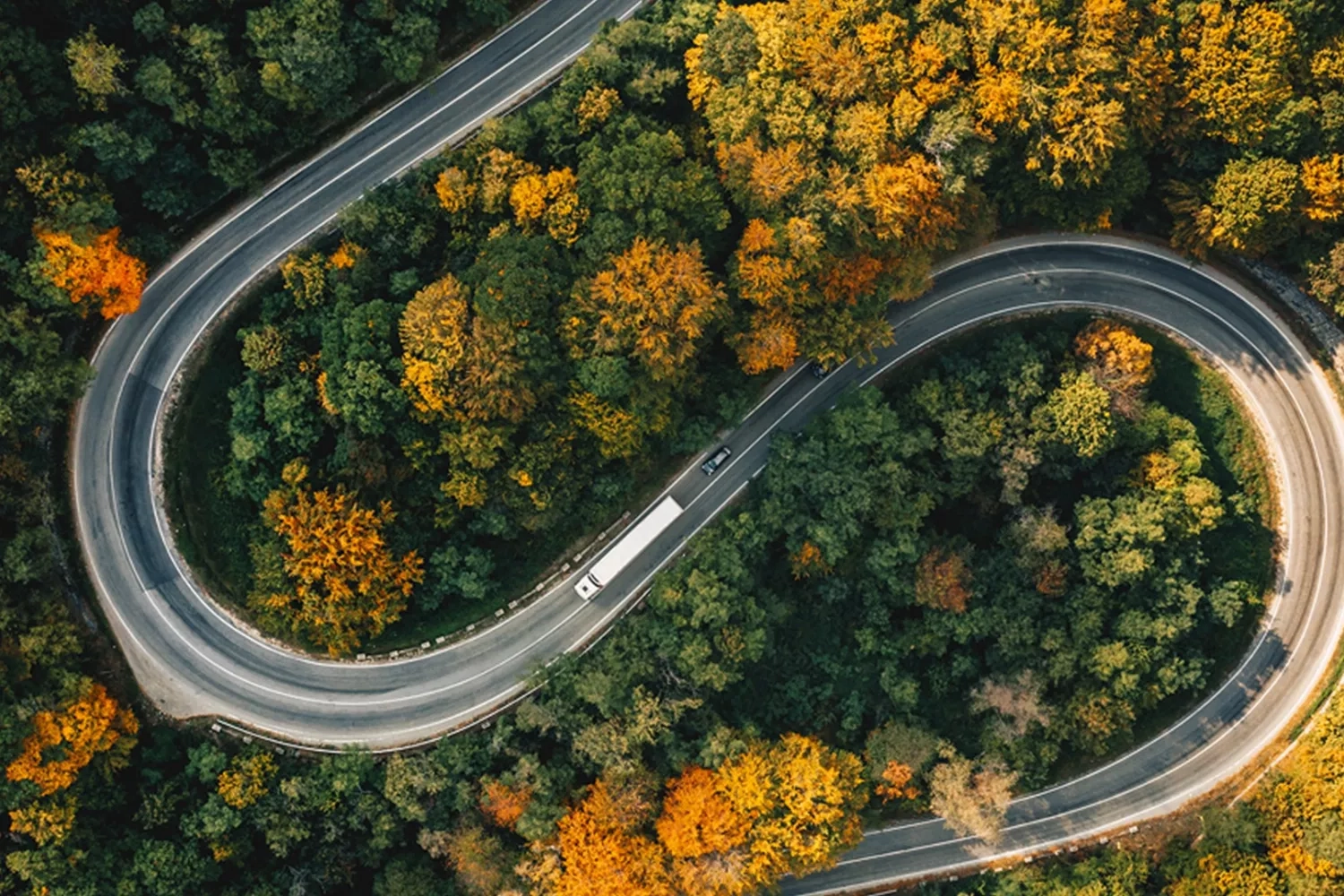 Truck driving up a curved road up a hill