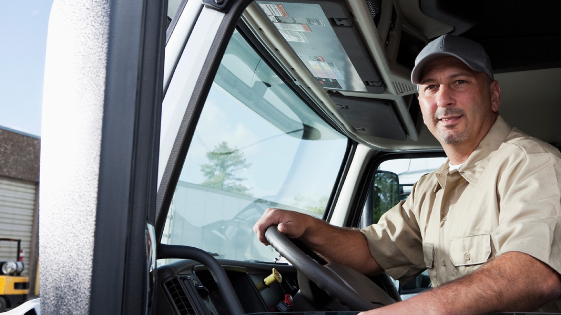 driver sitting in heavy-duty truck cab