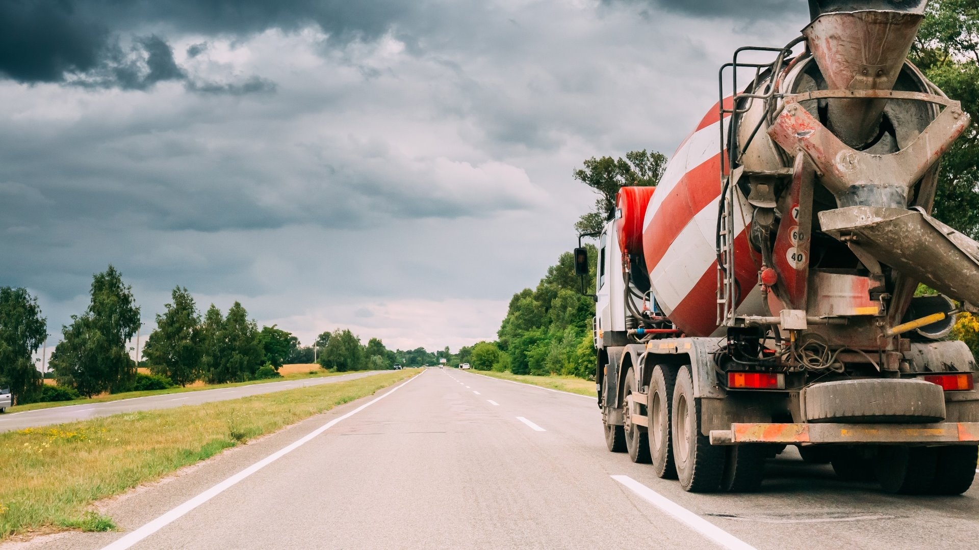 concrete mixer truck driving down road