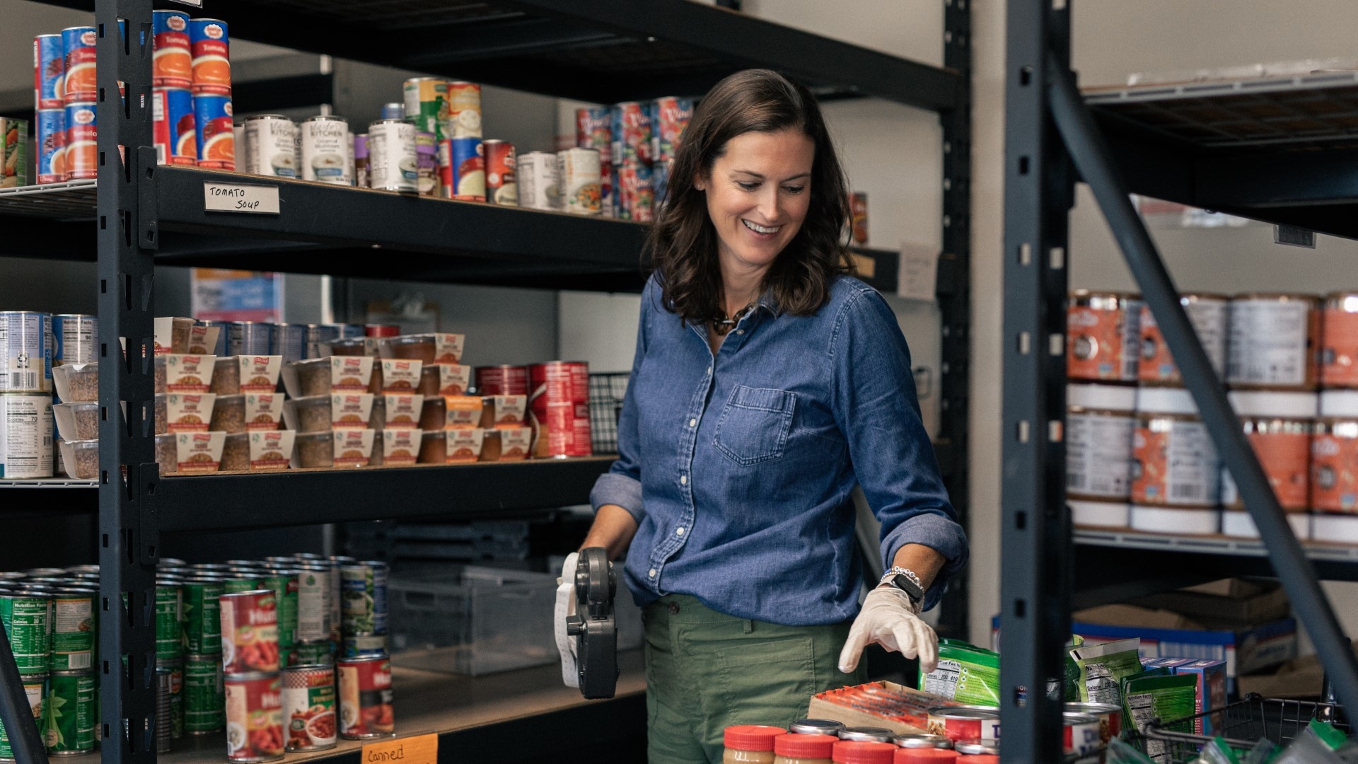 Katie Moreau help labeling goods in a food pantry