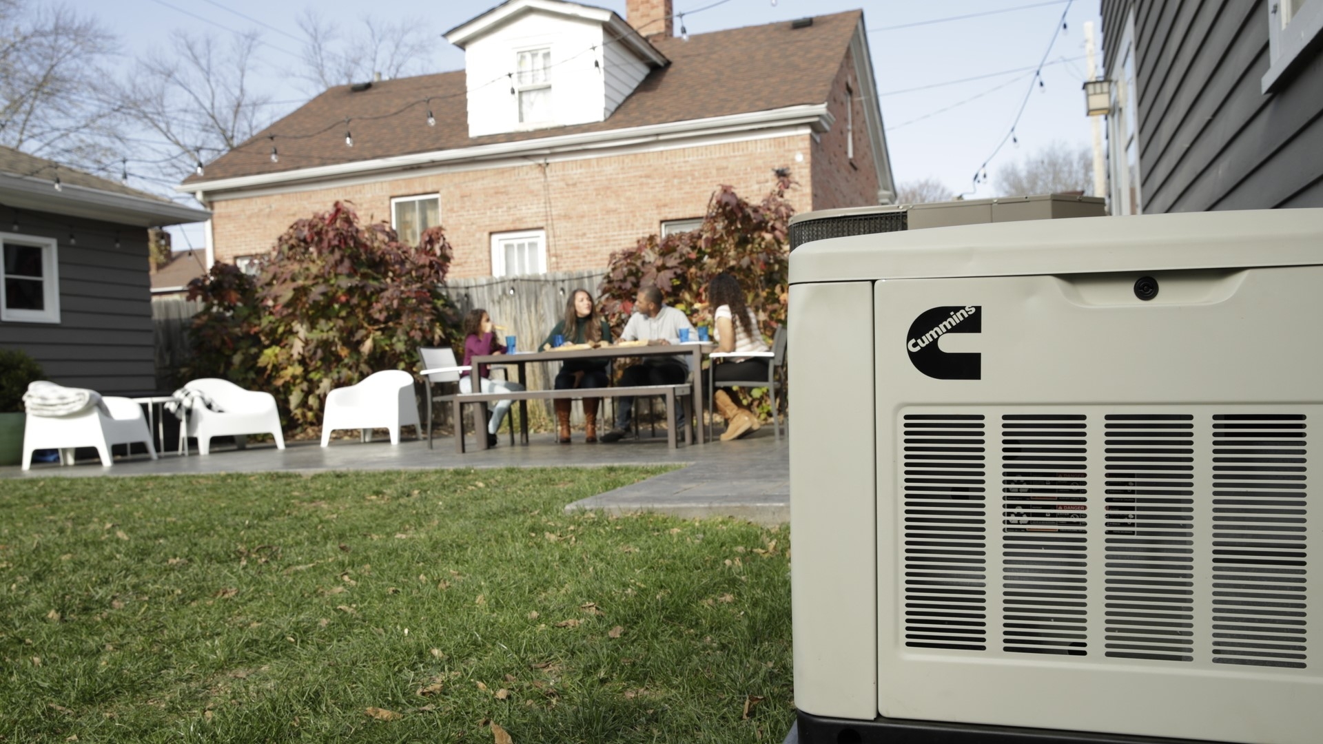 Cummins Home Standby generator with a family having a picnic