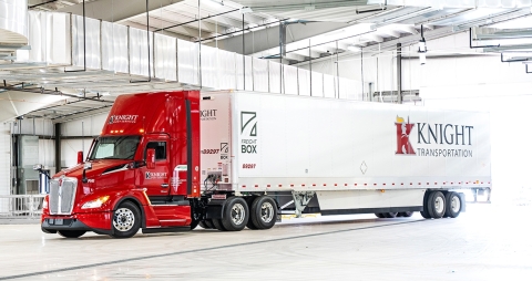 red and white Knight Transportation semi parked in an industrial garage