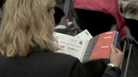 woman reading company pamphlet