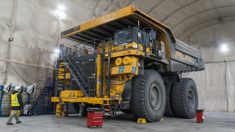 Large mining haul truck being serviced inside a maintenance facility