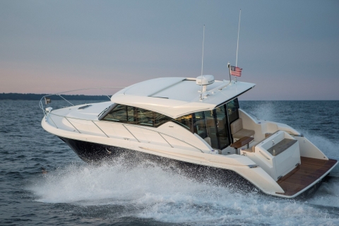 White cabin cruiser traveling across open water