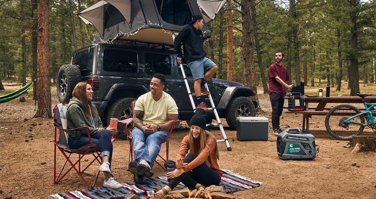 Friends around the fire at a campsite