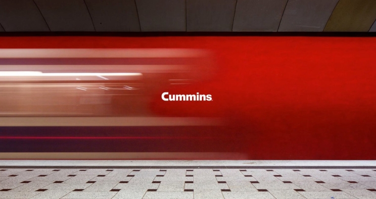 Cummins typeface on a red wall