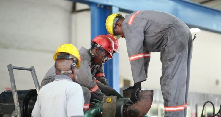 Workers inspecting a pipe