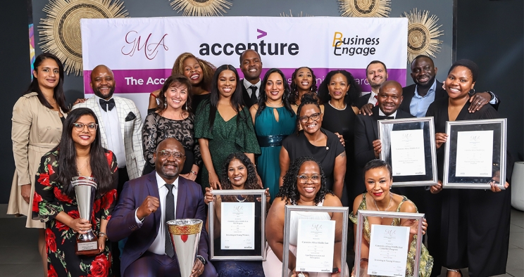 Employees smiling with awards