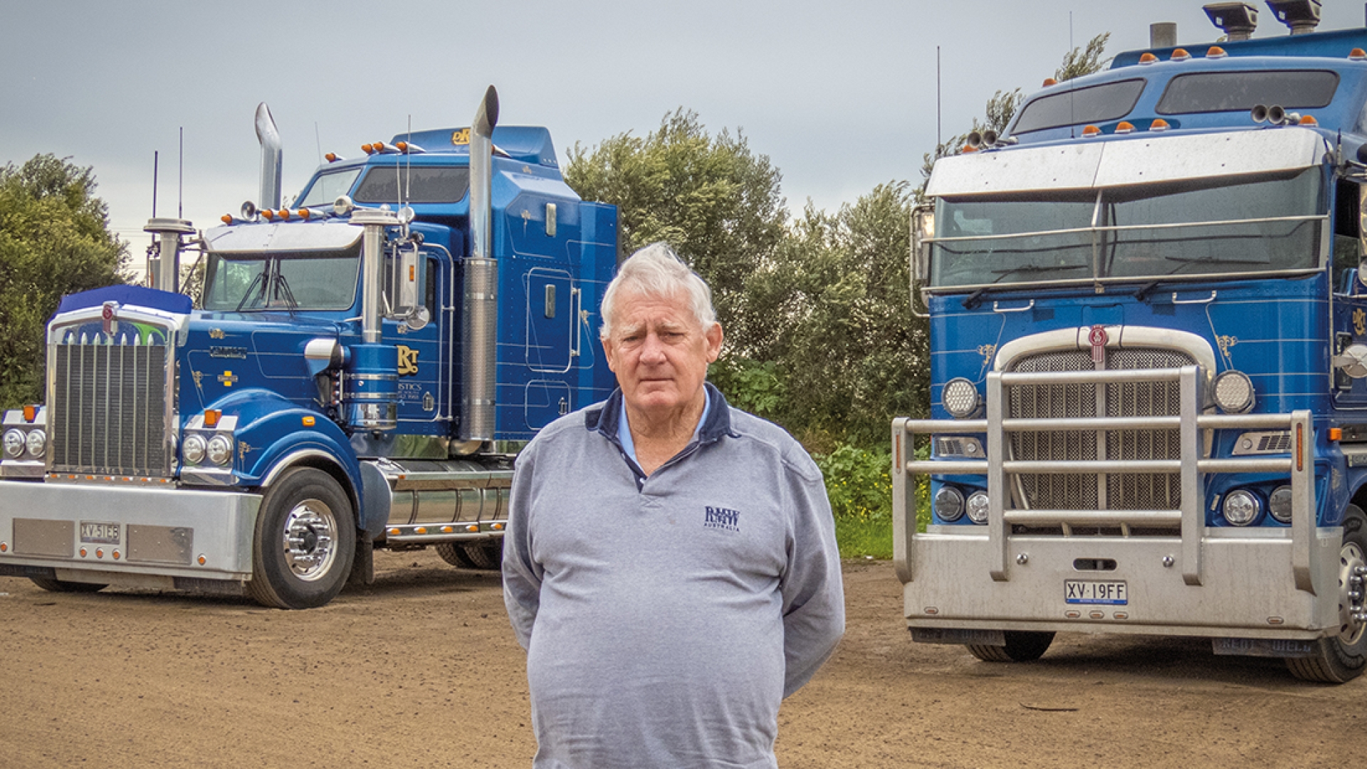 Shane standing in front of semis