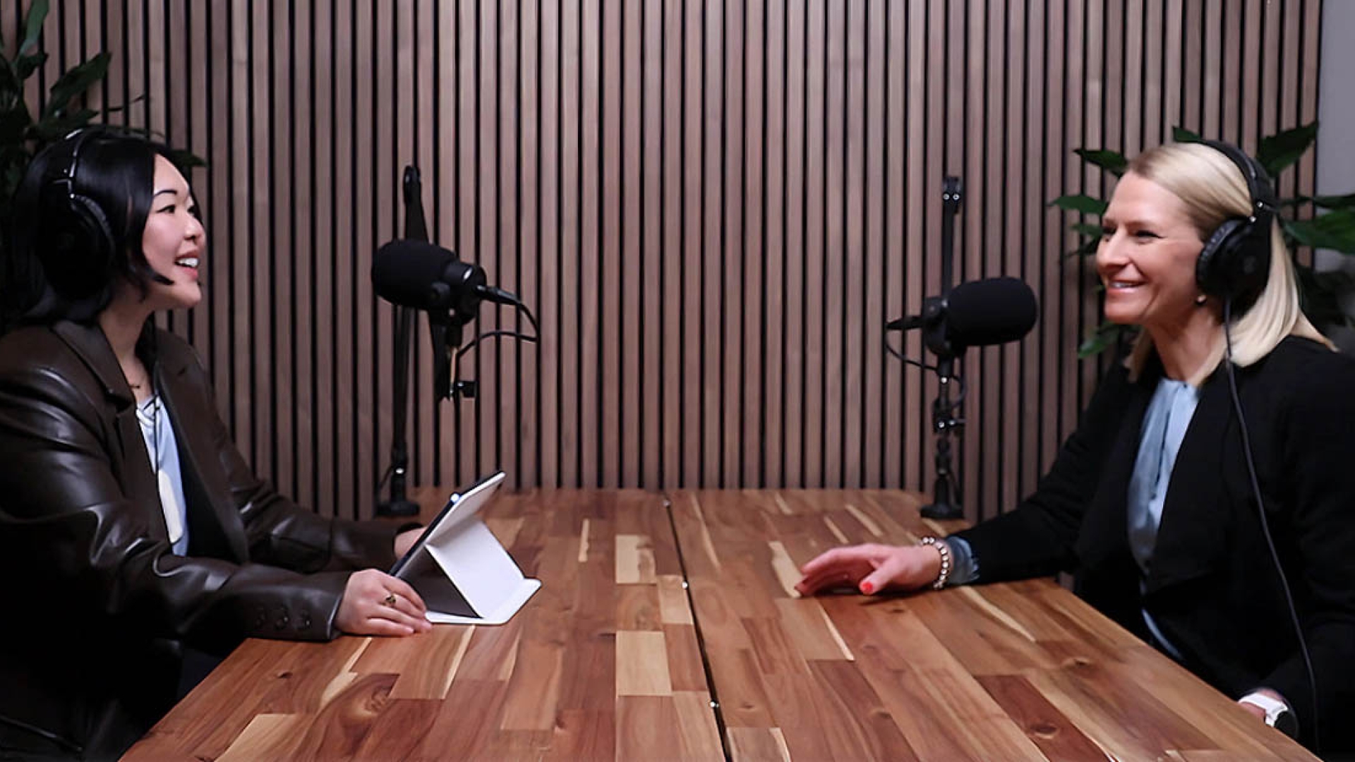 Podcast host and guest talking into microphones