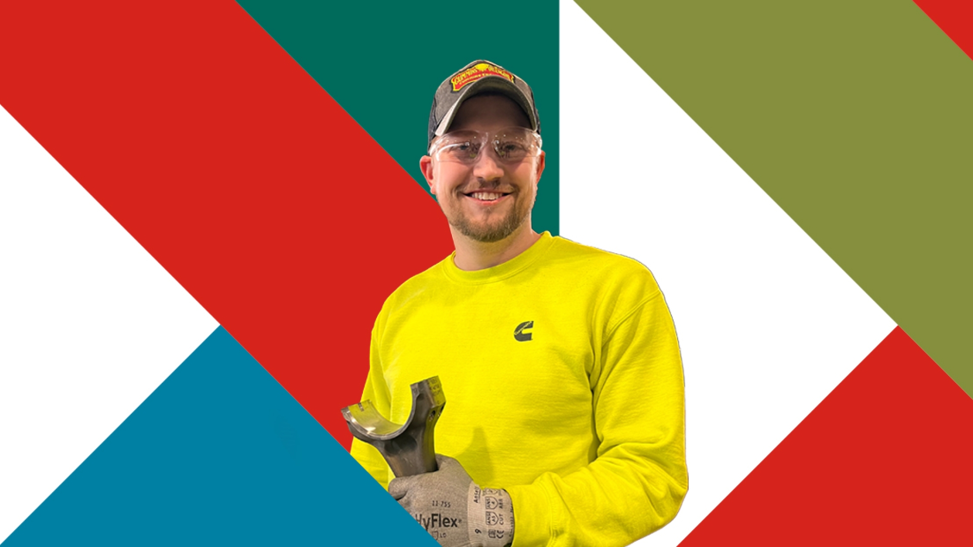 Employee holding an engine part