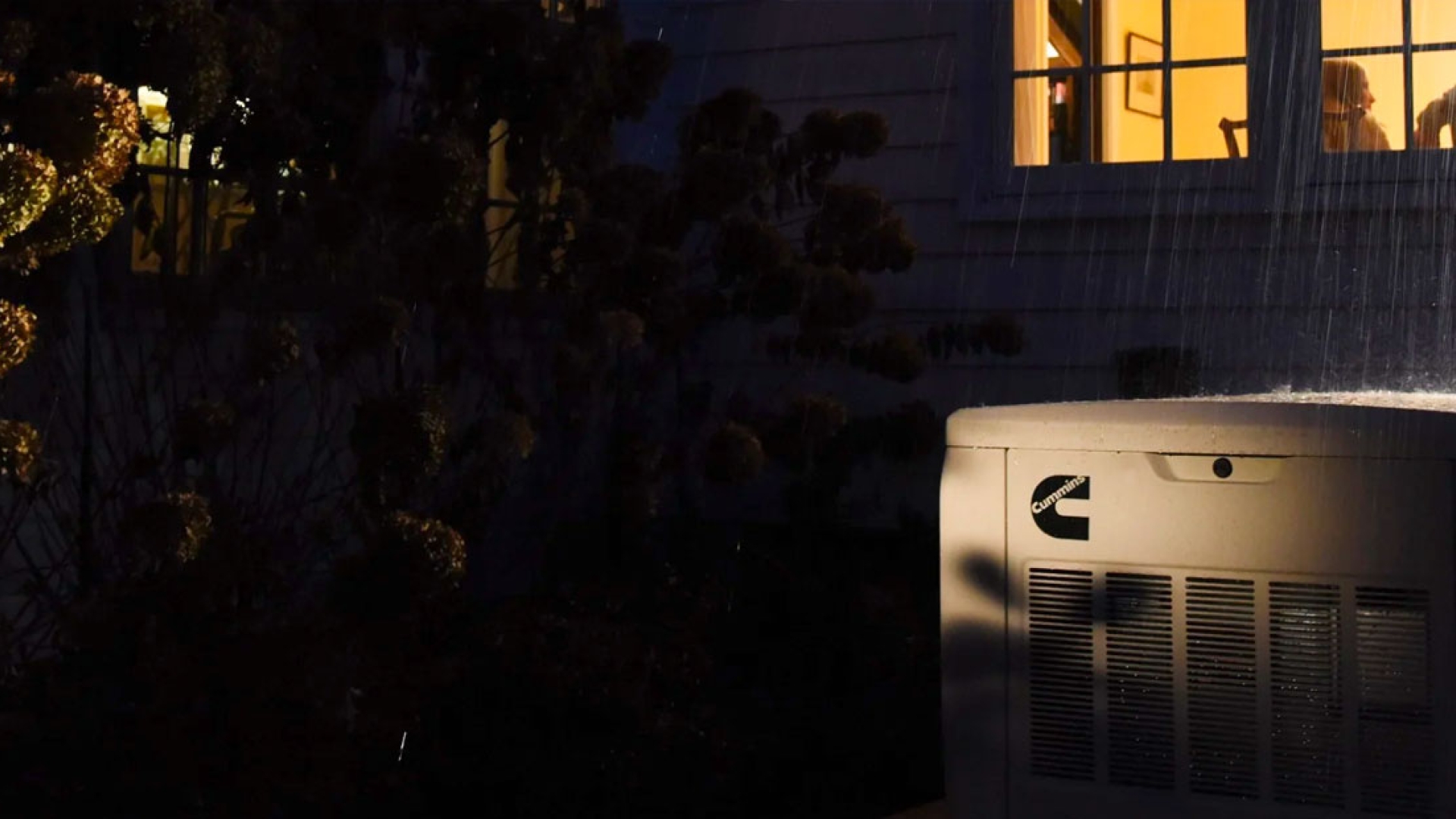 Cummins generator powering a home in the rain
