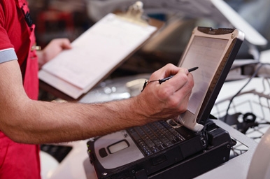 mechanic checking data on computer