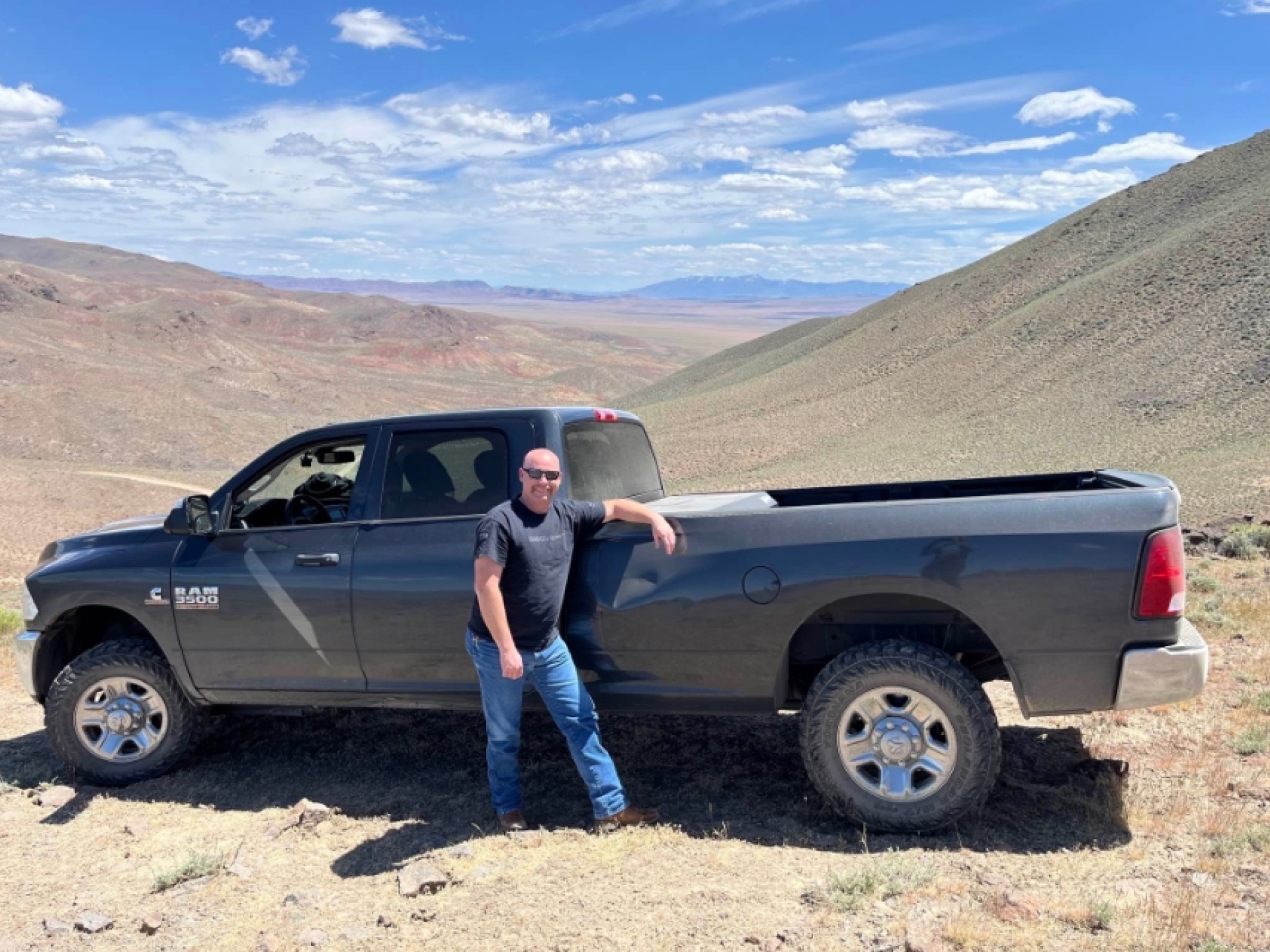 man standing next to pickup truck