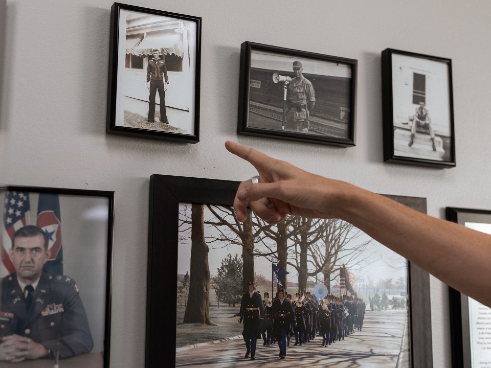 Pointing at a photo on the wall