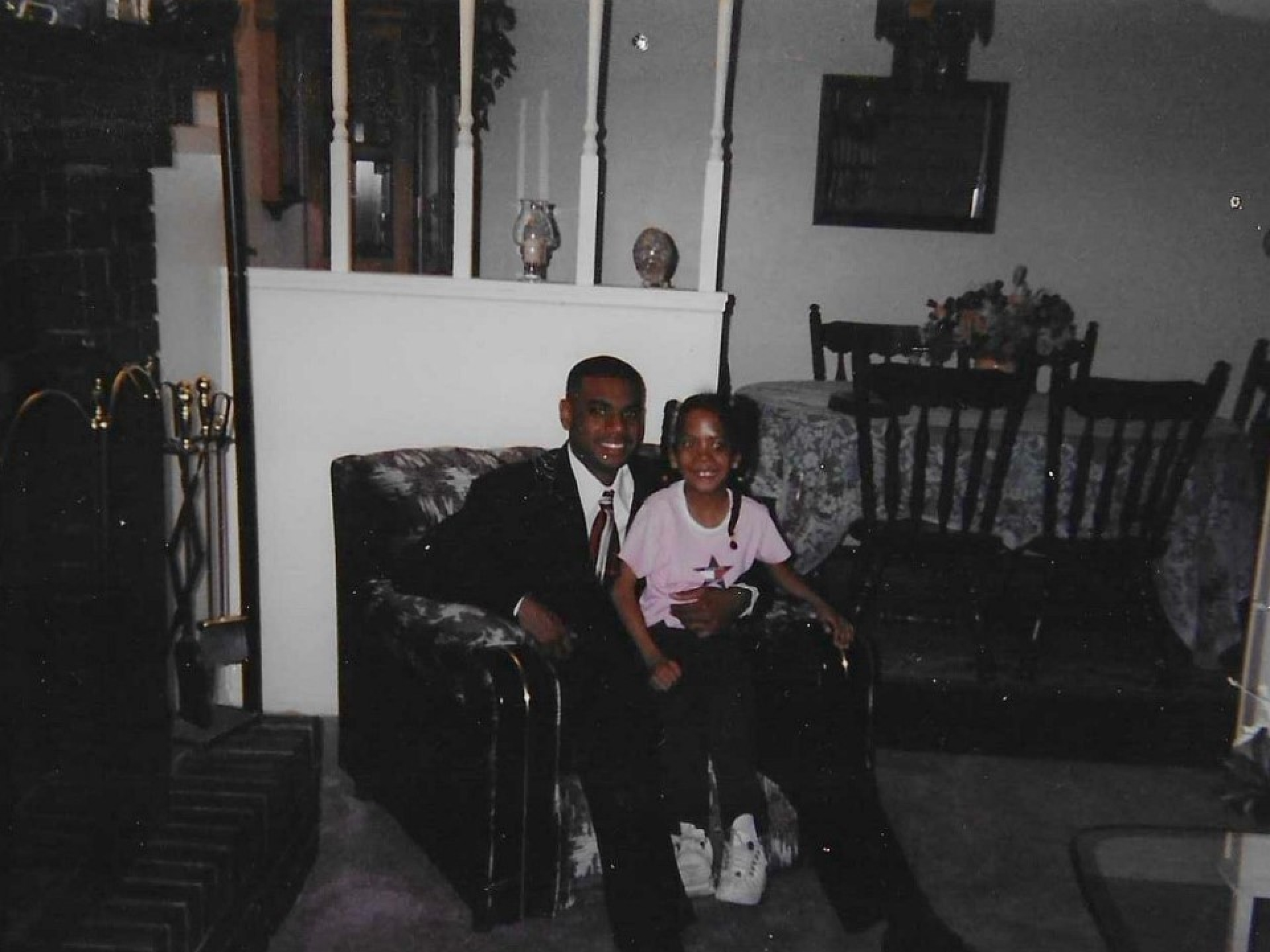 Shavonn sitting on a lap of a relative when she was younger