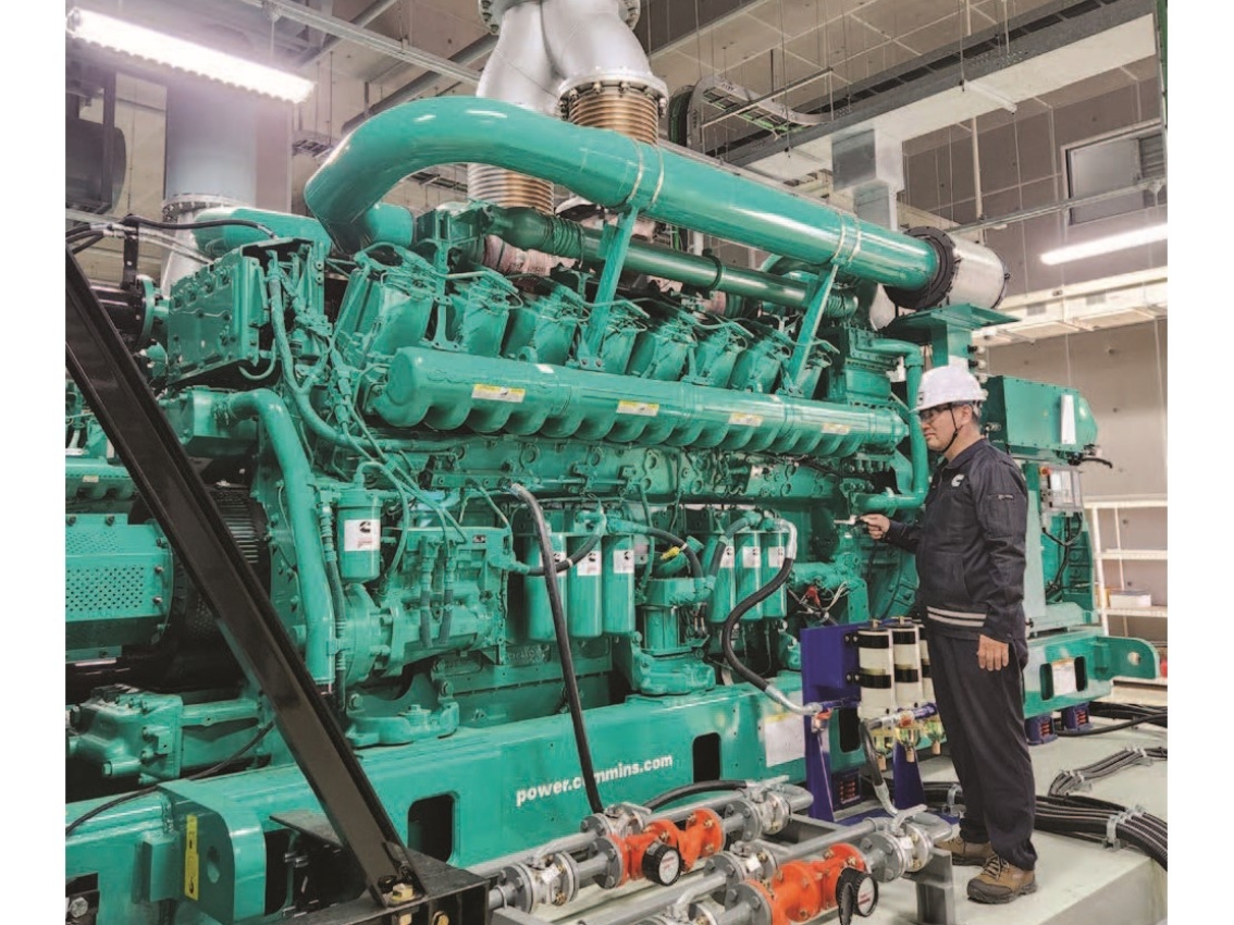 Worker next to Cummins generator