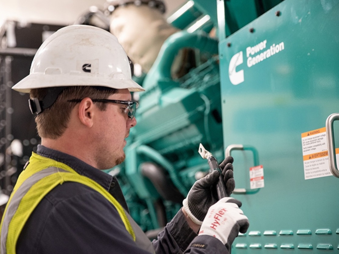 Cummins service technician servicing a generator