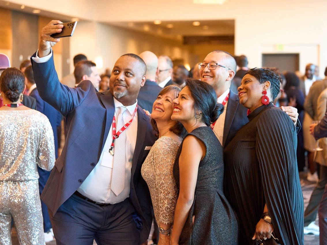 employees taking photo together at event