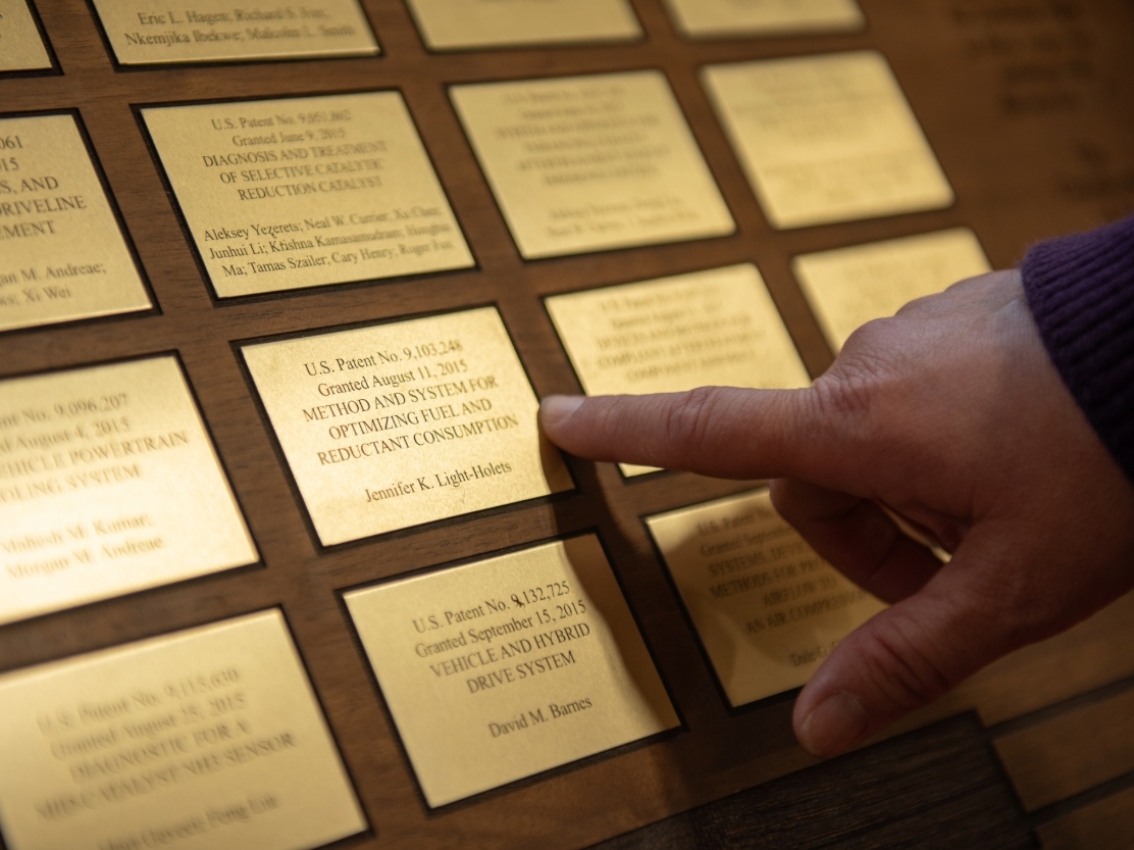 wooden board with plaques of patents