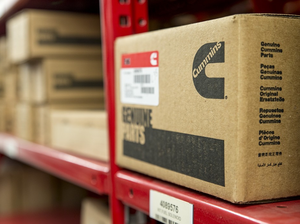 Box of Cummins genuine parts on red shelf