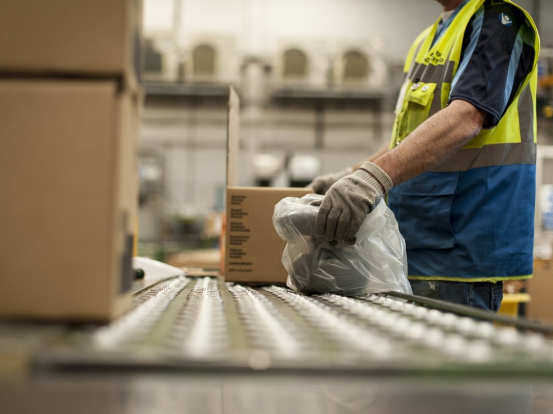 Worker unpacking a Cummins genuine part